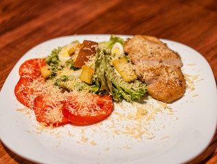 Grilled beef steaks on a plate with different vegetables