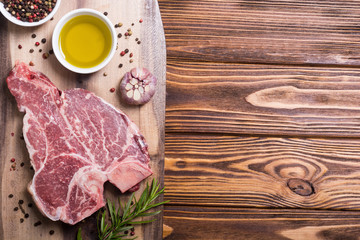 Raw beef steak T bone with ingredient
