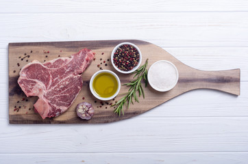 Raw beef steak T bone with ingredient