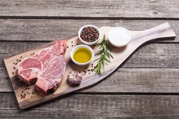 Raw beef steak T bone with ingredient