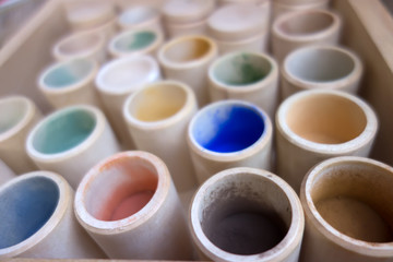 Jars with colorful paints background