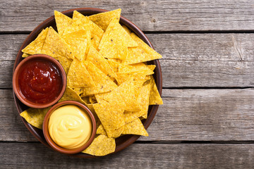 Crispy chips nachos with tomato and cheese sauce - obrazy, fototapety, plakaty
