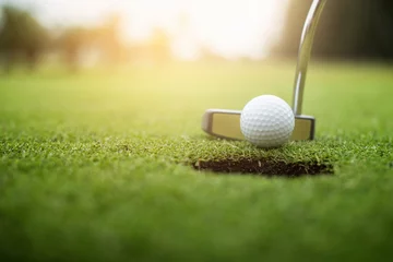Foto op Aluminium Golfer putting golf ball approach to the golf hole on the green golf. © ibravery