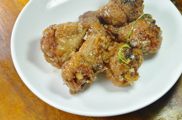 fried chicken leg with sweet sauce on dish