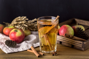 Glass of Tasty Cider with Apples and Spices on Rustic Wooden Background Christmas Beverage