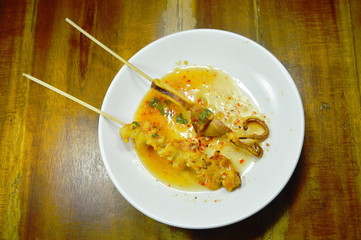 grilled squid dressing spicy sauce on white plate