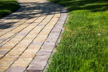 Sidewalk made from pavers running through a lawn