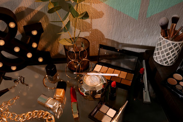 Decorative cosmetics and accessories on table indoors