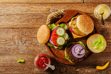 Homemade, beef hamburger with cheese and vegetables.