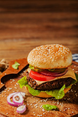 Homemade, beef hamburger with cheese and vegetables.