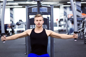 Athletic man training in modern gym