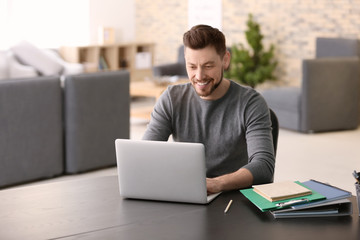 Freelancer working with laptop at home