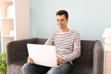 Young freelancer using laptop at home