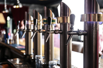 Draft beer taps in modern bar