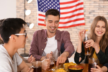 Friends drinking beer in bar