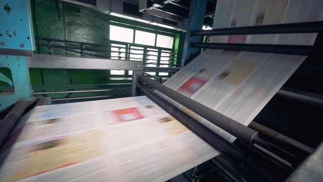 Newspaper printing equipment works at a plant, close up.