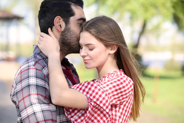 Obraz premium Happy young couple in park on spring day