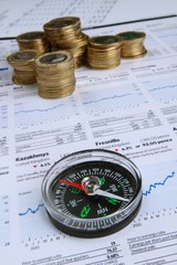 Compass And Coins On Financial Reports