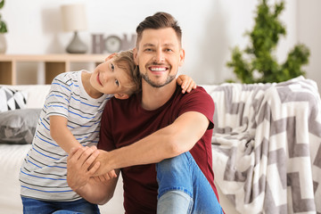 Little boy and his dad spending time together at home