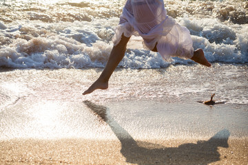 young woman legs running on the surf