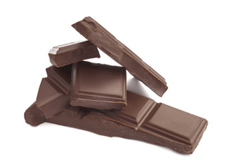 Delicious milk chocolate pieces on white background