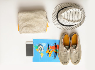Composition with world map, mobile phone, clothes and accessories on white background. Travel...