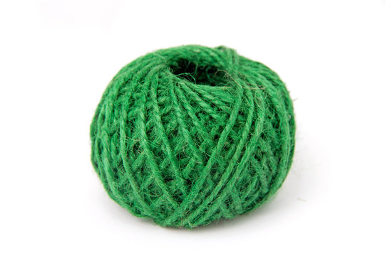 
Green tangle of thread for knitting on a white background