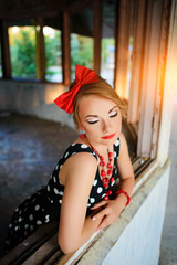 beautiful young woman posing in retro dress