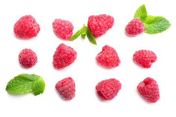 Delicious ripe raspberries with mint on white background