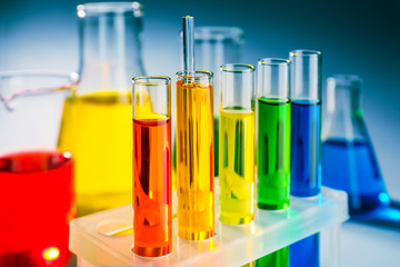 Test tubes with colorful liquids in holder, closeup