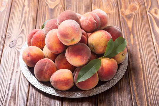 Ripe peaches fruit on rustic background