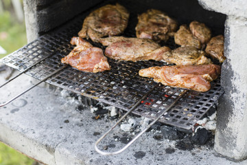 Loaded meat on grill grate.