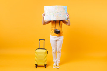 Traveler tourist woman in summer casual clothes, hat with suitcase, city map isolated on yellow...