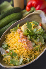 Salmon and vegetables salad with yellow cheese