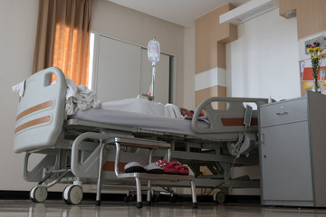 The modern adjustable position bed with lying patient at hospital.