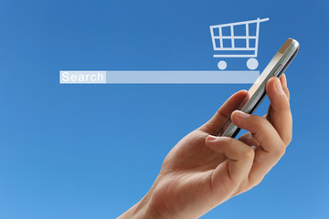 hand of a businessman holding a smartphone and have Shopping cart symbol.