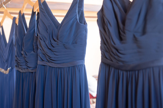 Wedding Dress And Blue Bridesmaids Dresses Hanging