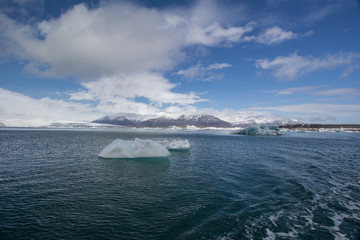Icebergs in Jökulsárlón glacier lagoon on Iceland overseeing a mountain