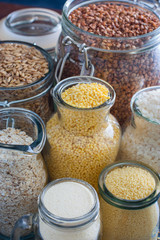 Rice (white and black), millet, oatmeal (ground and in grains), couscous, buckwheat, semolina in teklyannoy dishes, selective focus
