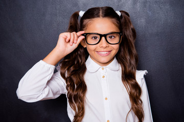 Portrait of cheerful nice adorable cute lovely small little girl with curly ponytails in white...