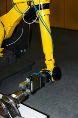 Yellow welding plasma kuka robot hand using in heavy industry for manufacturing, engineer...
