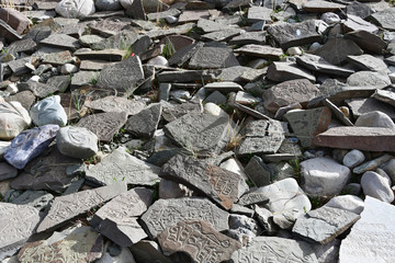 Tibet. Buddhist prayer stones with mantras and ritual drawings on the trail from the town of Dorchen around mount Kailash