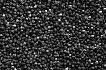 Black pepper close-up with blur effect in black and white.