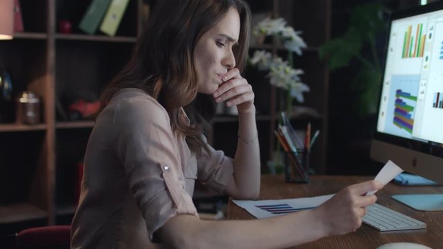 Frustrated business woman working on computer with economic data in home office. Upset woman manager leaning back on chair. Business crisis concept. Female boss thinking business solution