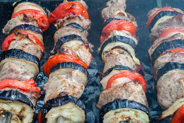 Juicy slices of meat with sauce prepare on fire shish kebab