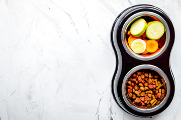 Vegetables and petfood on kitchen table background top view mock