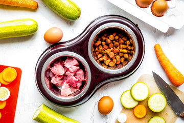 petfood set with vegetables and meat on kitchen table background