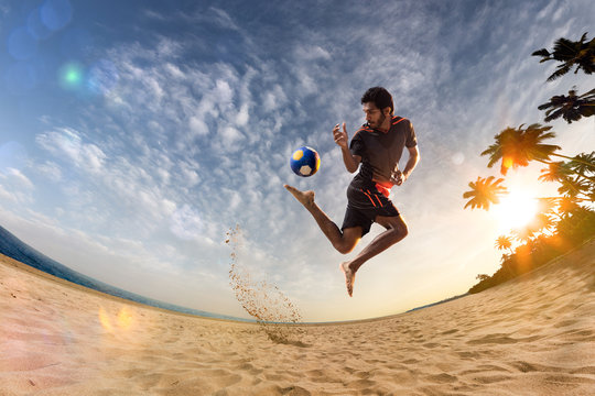 Beach Soccer Player In Action. Sunny Beach Wide Angle