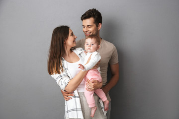 Portrait of a smiling young family with their little baby girl