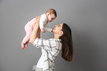 Portrait of a cheerful young mother playing